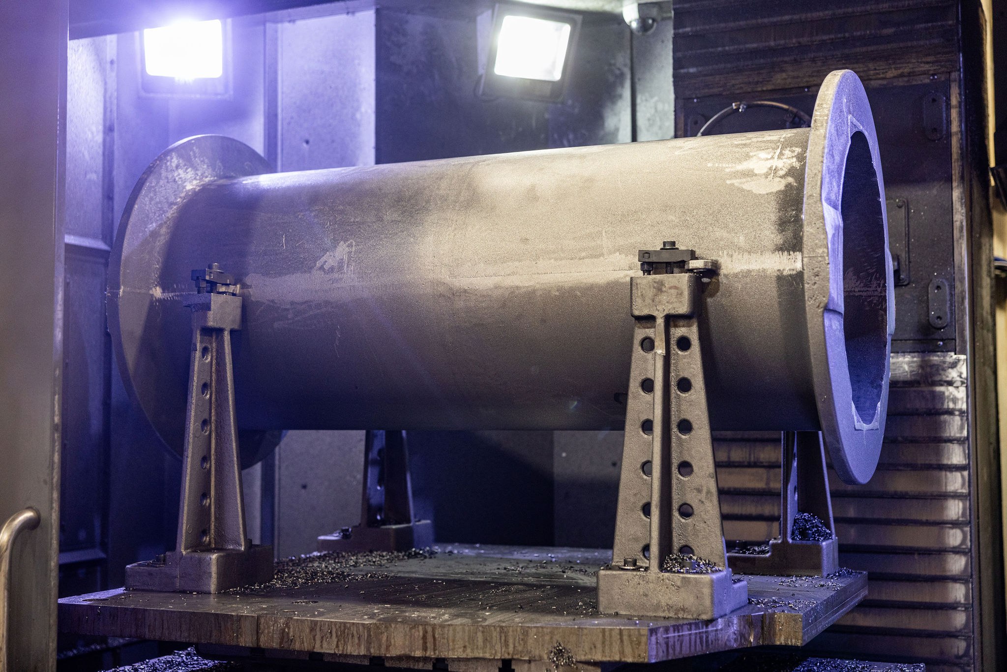 Large near-net-shape casting fixtured on the CNC bed for finish machining — short-run cast turbine or energy component after pour, ready for critical bore, sealing face, and bolt pattern machining.
