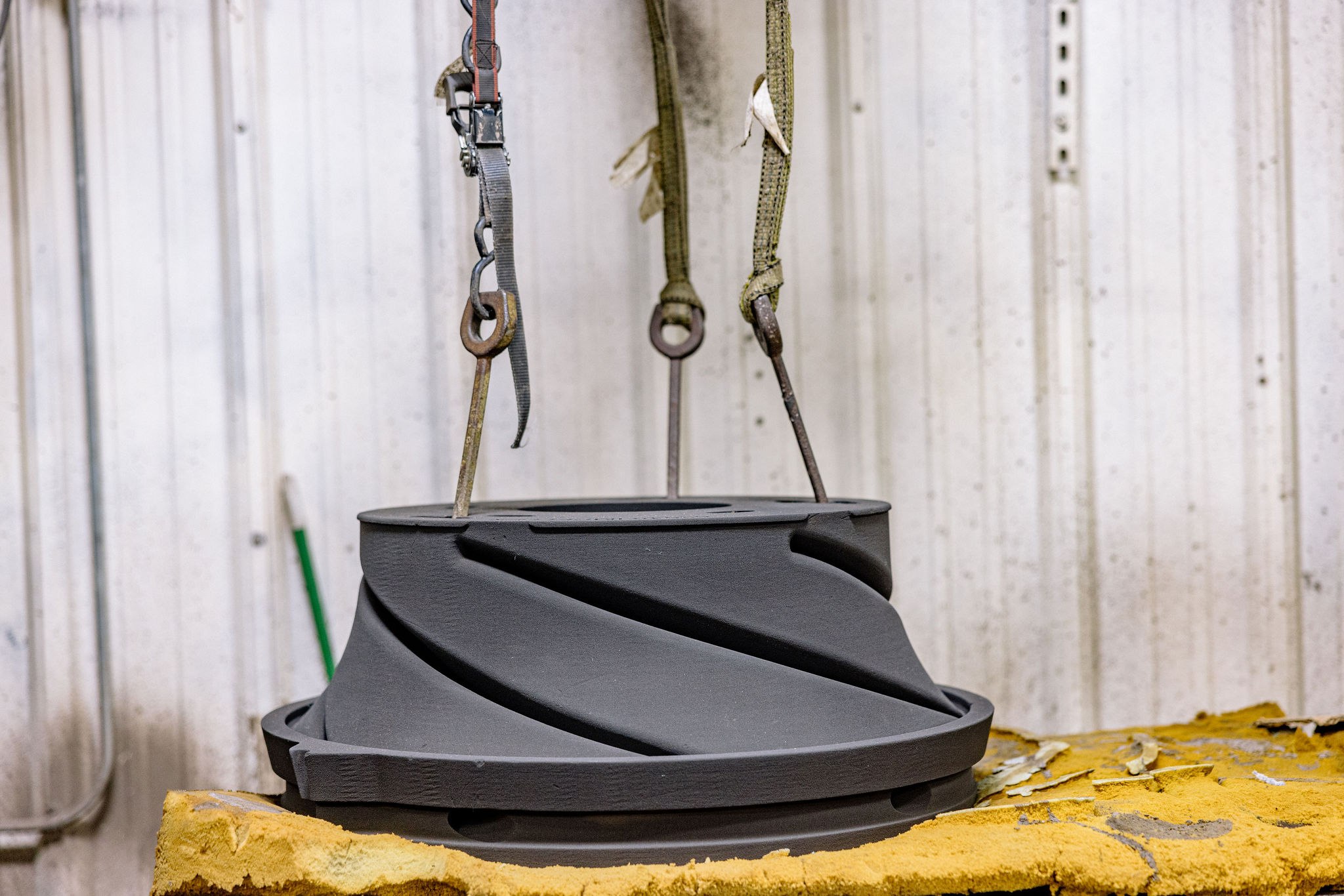 Cast stainless impeller after final CNC machining and dye-penetrant inspection, rigged for shipping — representative of the pump wet-end parts we run at the 1–100 piece scale.