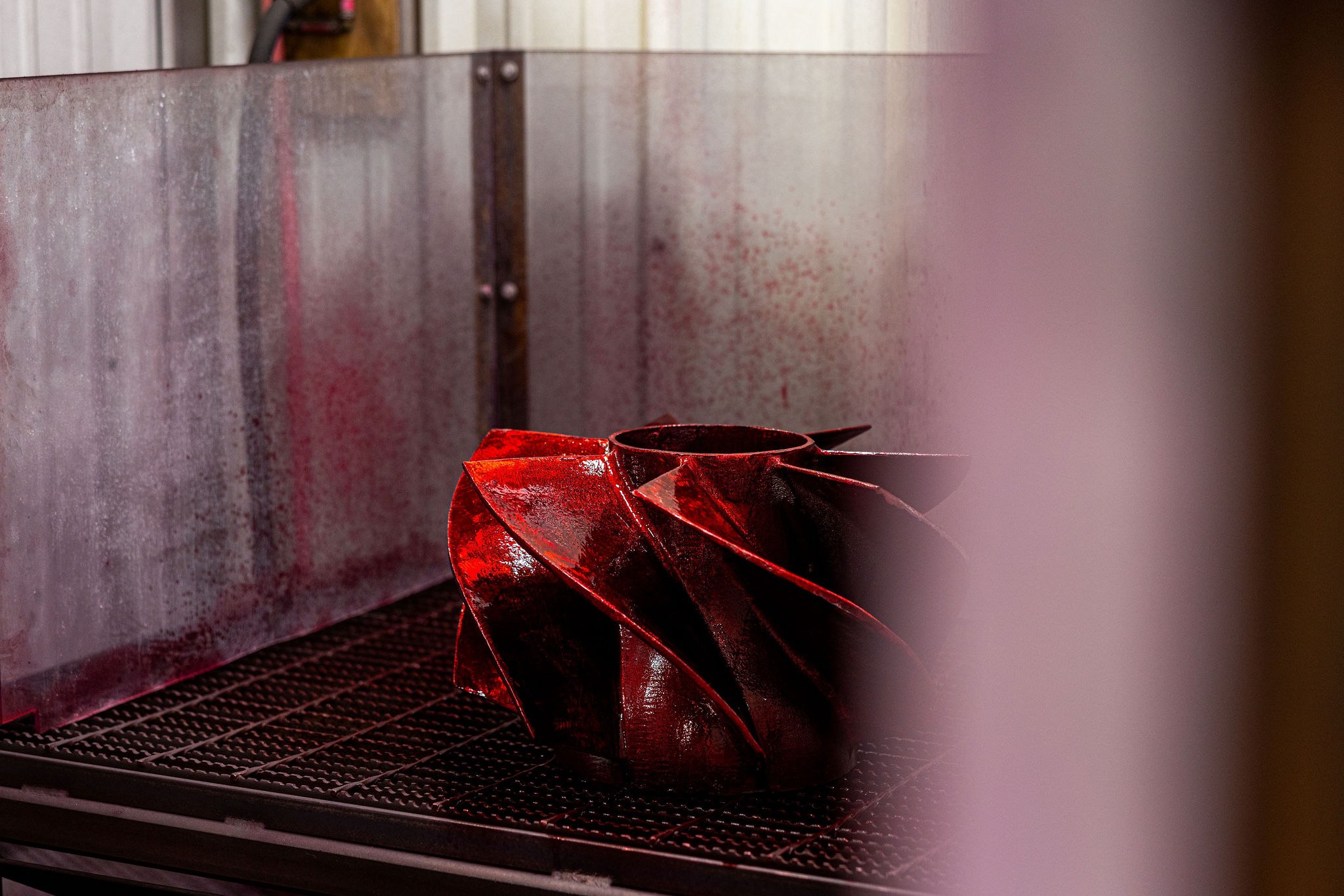 Liquid penetrant inspection to ASTM E165 on a machined critical surface of a stainless-steel casting, red developer highlighting the acceptance surface prior to First Article release.