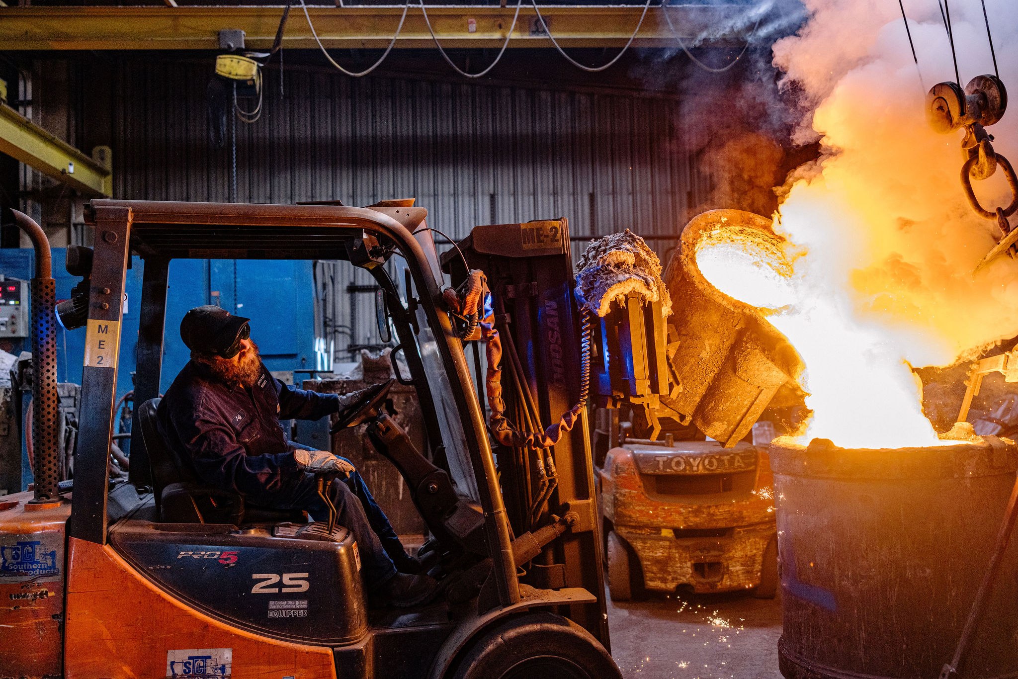 Molten stainless steel pour on the foundry floor into a 3D-printed sand mold — short-run cast turbine component in ASTM A487 or A743 CA6NM martensitic stainless, patternless workflow.